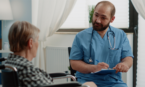 doctor talking with elderly patient