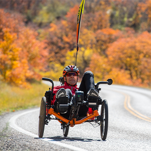 Bob riding his trike down a mountain road