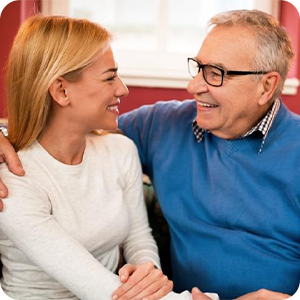 Elderly man talking with younger woman