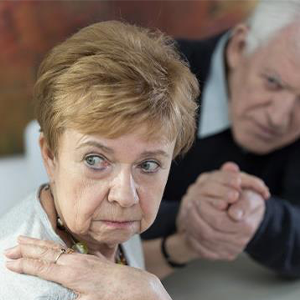 A elderly woman with a concerned look on her face