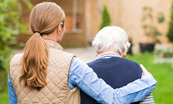 Young woman with arm around elderly woman