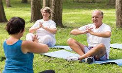elderly people doing yoga class