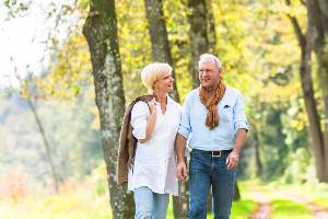 elderly couple walking outside