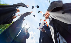 people throwing graduation caps into the air