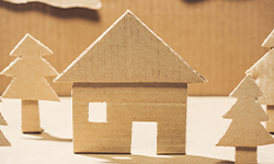 image of cardboard house and cardboard trees
