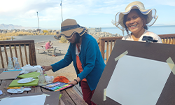 women painting outside