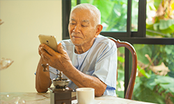 elderly man looking at a smartphone